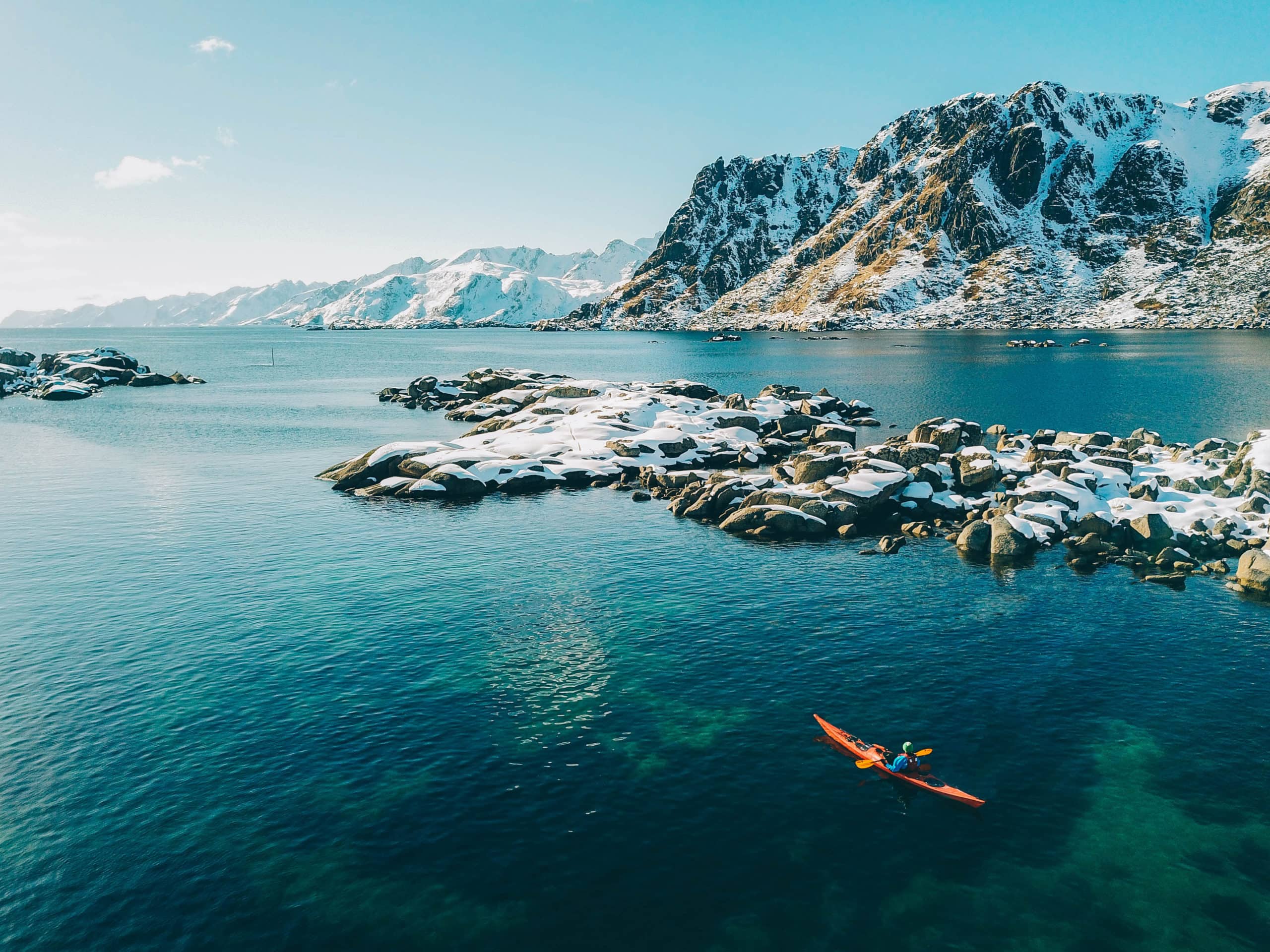 Sea kayak in lofoten with majestic mountains in the background.